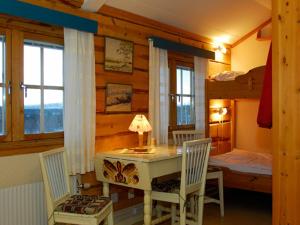 a bedroom with a desk and a bunk bed at Vålådalens Fjällstation in Vålådalen