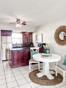 a kitchen with a white table in a room at Knot a Care Remodeled Direct water access condo with ocean and pool views NOW SLEEPS SIX in Marco Island