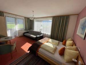 a bedroom with a bed and a living room at Appartment Sonnenschein in Uttendorf
