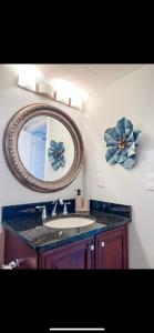 a bathroom with a sink and a mirror at Knot a Care Remodeled Direct water access condo with ocean and pool views NOW SLEEPS SIX in Marco Island