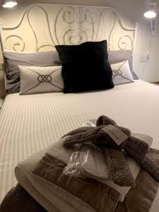 a bed with a blanket and pillows on it at Maison de Maff in Pesaro