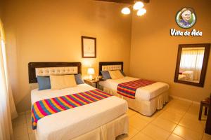 a hotel room with two beds in a room at Hotel de Campo Villa de Ada in Gracias