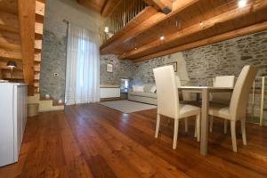 a kitchen and living room with a table and chairs at Cà 'd Calin Casa nel Borgo in Serralunga d'Alba