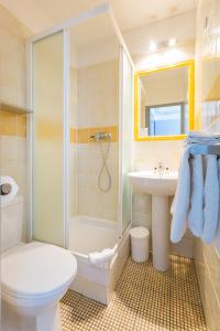 a bathroom with a shower toilet and a sink at Europe Hotel Vieux Port in Marseille