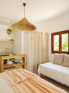 a bedroom with two beds and a chandelier at Appartamentos Michel Dos in Sant Ferran de Ses Roques