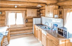 a kitchen with wooden cabinets and a stove top oven at Amazing Home In Kopalino With 2 Bedrooms And Wifi in Kopalino