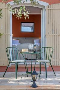 a table and chairs on a patio with a bedroom at Domaine Rabiega - Vineyard and Boutique hotel in Draguignan