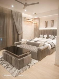 a bedroom with two beds and a tub in it at The Origin Suites DLF MY PAD in Lucknow