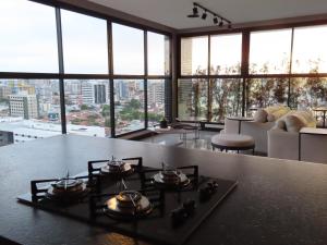 a kitchen with a table with pots and pans on it at Elegante quarto e sala Sky Concept 418 Novissímo in Maceió