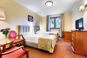 Postel nebo postele na pokoji v ubytování Hotel Pan Tadeusz