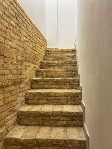 a stone stairway with a brick wall at Agradable adosado con zona de aparcamiento in Sedaví