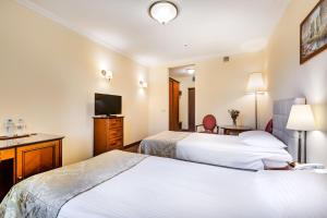 Postel nebo postele na pokoji v ubytování Hotel Pan Tadeusz