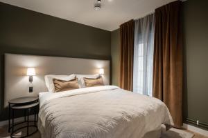 a bedroom with a large bed and a window at Live and Stay Ekmanska in Gothenburg