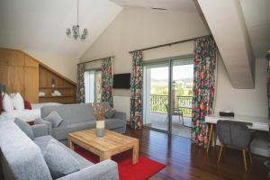 a living room with a couch and a table at Le Palais des Cerisiers in Azrou