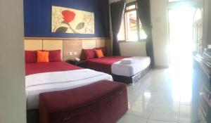 A bed or beds in a room at Ahlen Pangandaran