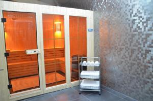 a bathroom with a shower with a cart in it at Hotel Orion Tbilisi in Tbilisi City