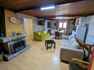 a living room with a couch and a fireplace at Casas do Pastor in Seia