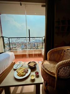 a room with a table with a plate of food at Hotel Kesu Home in Kathmandu