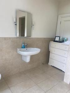 a bathroom with a sink and a mirror at Redgate House Bed & Breakfast in Derry Londonderry