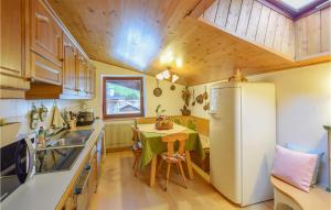 a small kitchen with a table and a refrigerator at Nice Apartment In Racines-ratschings With Wifi in Stanghe