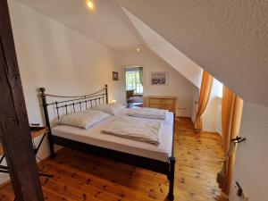 a bedroom with a bed in a room with an attic at Ferienwohnung mit Flair in Dresden