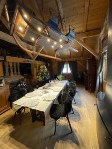 a dining room with a long table with chairs at Chalet Alpage Proche Genève in Mégevette