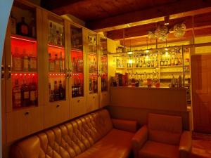 a bar with a couch and many bottles of alcohol at DOBRA RAKIJA - transit sleep in Dobra