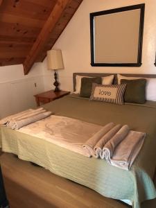 a large bed in a room with a mirror at Breckenridge Chalet near Yosemite. Dog friendly! in Groveland