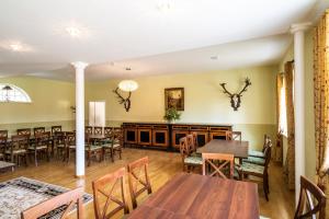a dining room with wooden tables and chairs at Quartier Rautenstock GbR in Doberlug-Kirchhain