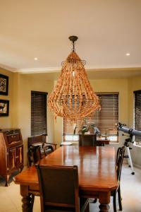 a chandelier hanging over a dining room table at Cwebile Guesthouse in Winterton