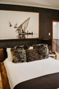 1 dormitorio con 1 cama con una foto de un barco en Cwebile Guesthouse, en Winterton