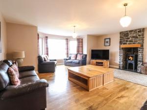 a living room with a couch and a coffee table at Luxury Highland Home in Scotlands' Great Glen in Gairlochy