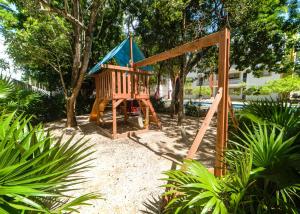 a playground with a blue roof and a swing at Cancun Airport Condo Hotel Apartment with pool and security in Cancún