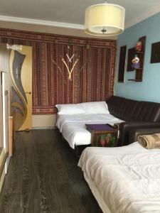 a hotel room with three beds and a couch at Apartment Na Lidzava Beach in Pizunda