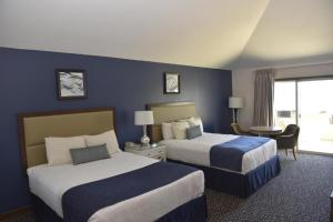 a hotel room with two beds and a window at Bodega Coast Inn and Suites in Bodega Bay