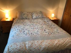 a bedroom with a bed with two lamps on both sides at Modern 3-bedroom townhouse in the Mournes in Newry