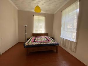 a bedroom with a bed in the corner of a room at Authentic house with a huge garden in Utsera