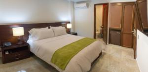 a bedroom with a large bed in a hotel room at Hotel Palonegro in Bucaramanga