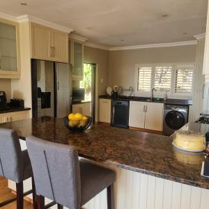 a kitchen with a counter with a bowl of fruit on it at Luxury Home with breathtaking views of Champagne Valley in Bergview