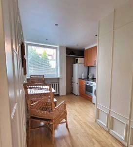 a kitchen with a table and a chair in a room at Stasys Apartments Pilies Street in Vilnius