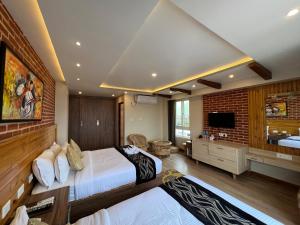 a bedroom with a large bed and a brick wall at Hotel Kesu Home in Kathmandu
