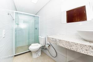 a bathroom with a toilet and a sink and a shower at Pousada Maanaim Porto in Porto De Galinhas