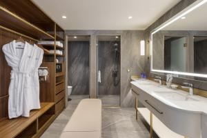 a bathroom with two sinks and a shower at Titanic Port Bakirkoy in Istanbul