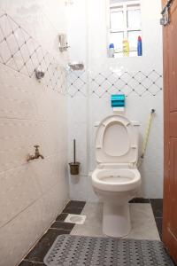 a bathroom with a toilet with the lid up at Nelly fully furnished studios in Naivasha