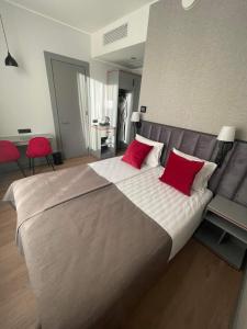 - une chambre avec un grand lit et des oreillers rouges dans l'établissement Tõrva Veemõnula Spaahotell, à Tõrva
