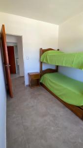 a bedroom with two bunk beds and a hallway at Alquiler temporal casa Bialet Masse con pileta, cancha de fútbol, mesa de pool y ping pong in Bialet Massé