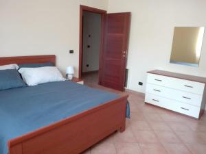 a bedroom with a bed and a dresser and a mirror at La casa di mezzo-affitti brevi-zona ospedali in Busso