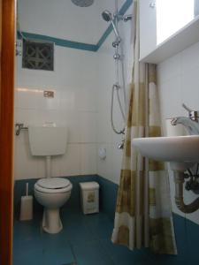 a bathroom with a toilet and a sink at Studios Lainis in Toroni