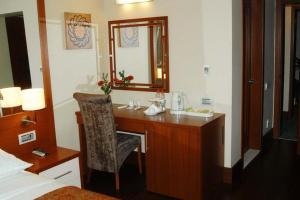 a bathroom with a desk with a mirror and a sink at Dareyn Hotel in Istanbul +92 photos