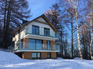 een huis op een heuvel in de sneeuw bij LUXURY OAK VILLAS in Bielsko-Biala